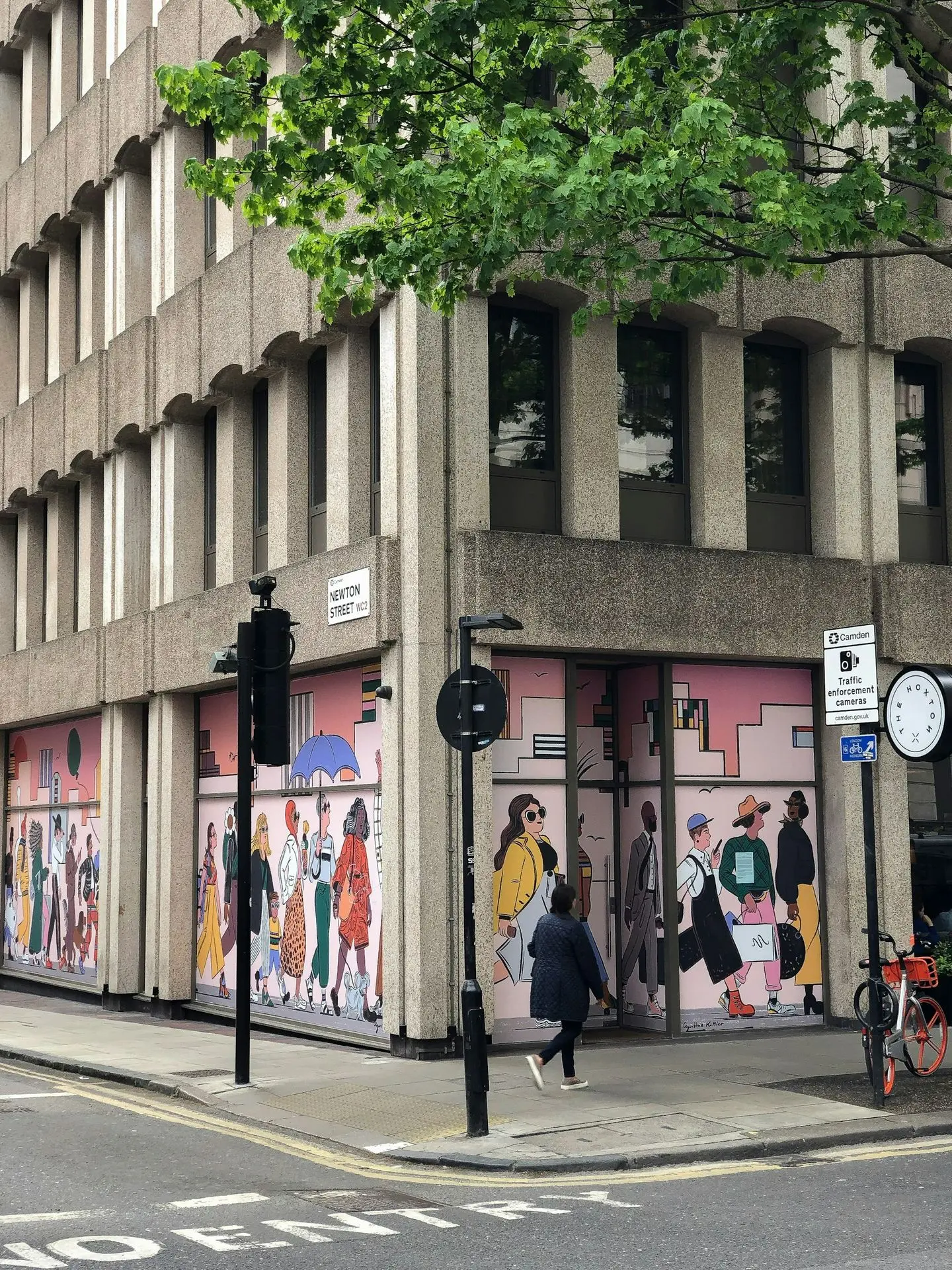 person walking on sidewalk near building